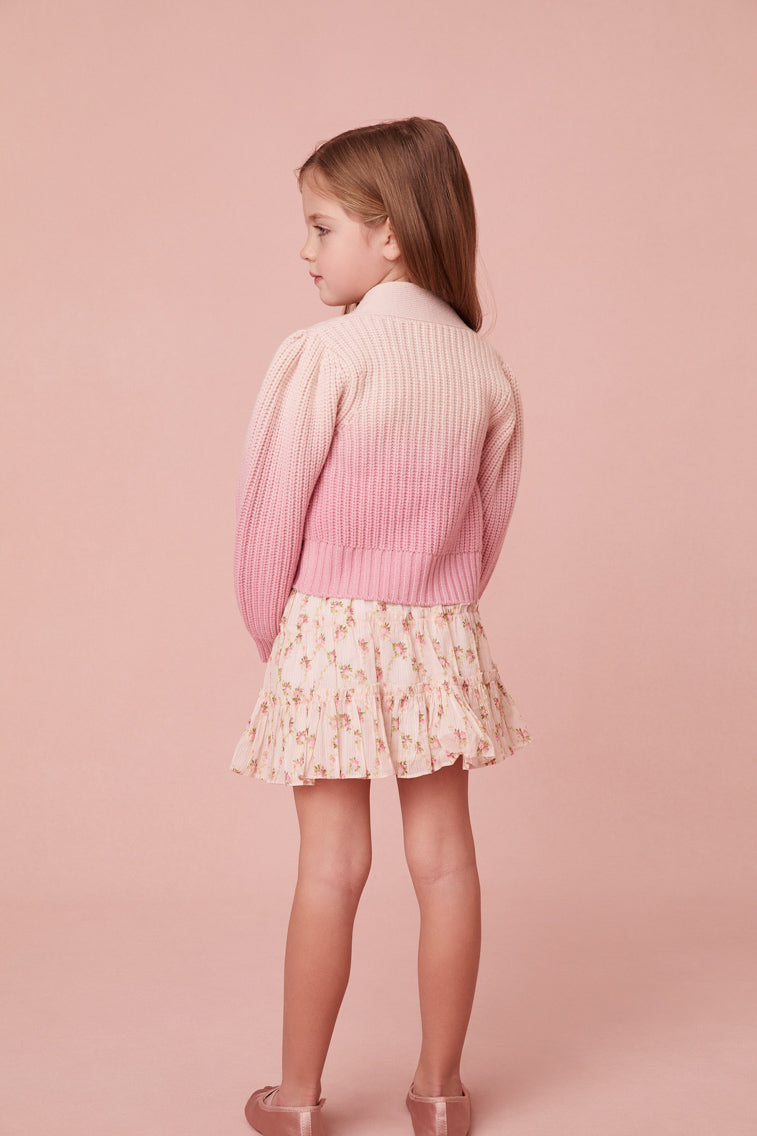 This sweater has a v-neck that descends to four flower buttons at center front. Pleated blouson sleeves extend to ribbed cuffs at opening and a dip-dye technique gives off a stunning gradient effect where it’s darker on the bottom and lighter on the top.