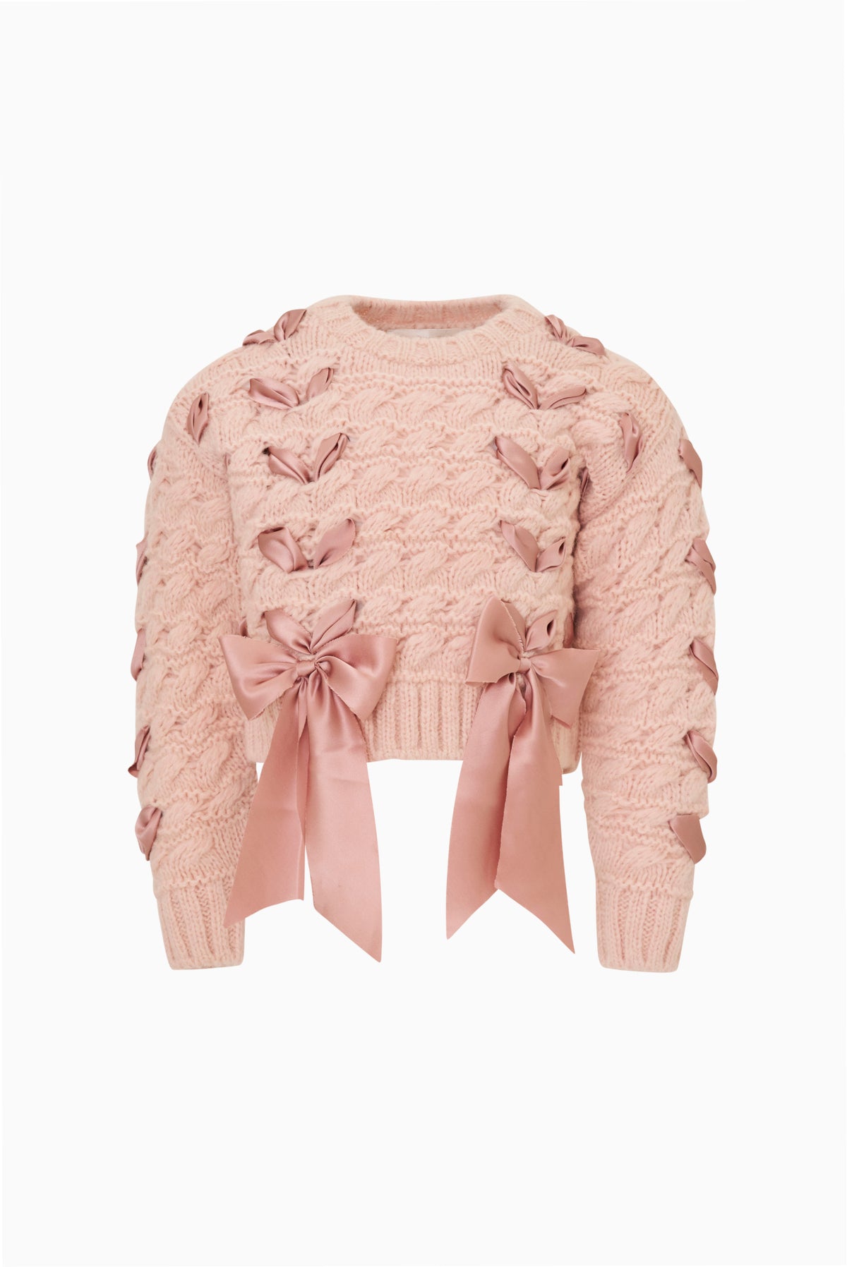 Girls' pink cable-knit cardigan close-up with large ribbon threaded through and bow at hem