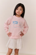 Little Girl wearing a pink american flag sweater and white skirt on a plain background