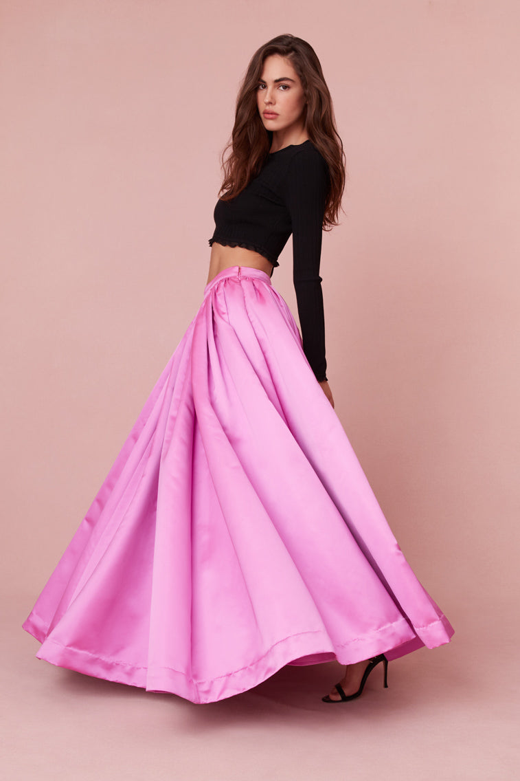 Maxi skirt features a fixed waistband before descending to a full, pleated skirt.