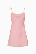 Pink camisole dress with thin straps on a white background