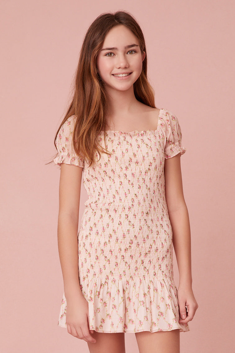 dress features our favorite new dainty floral print of the season, short puff sleeves, a smocked bodice, and an airy skirt.