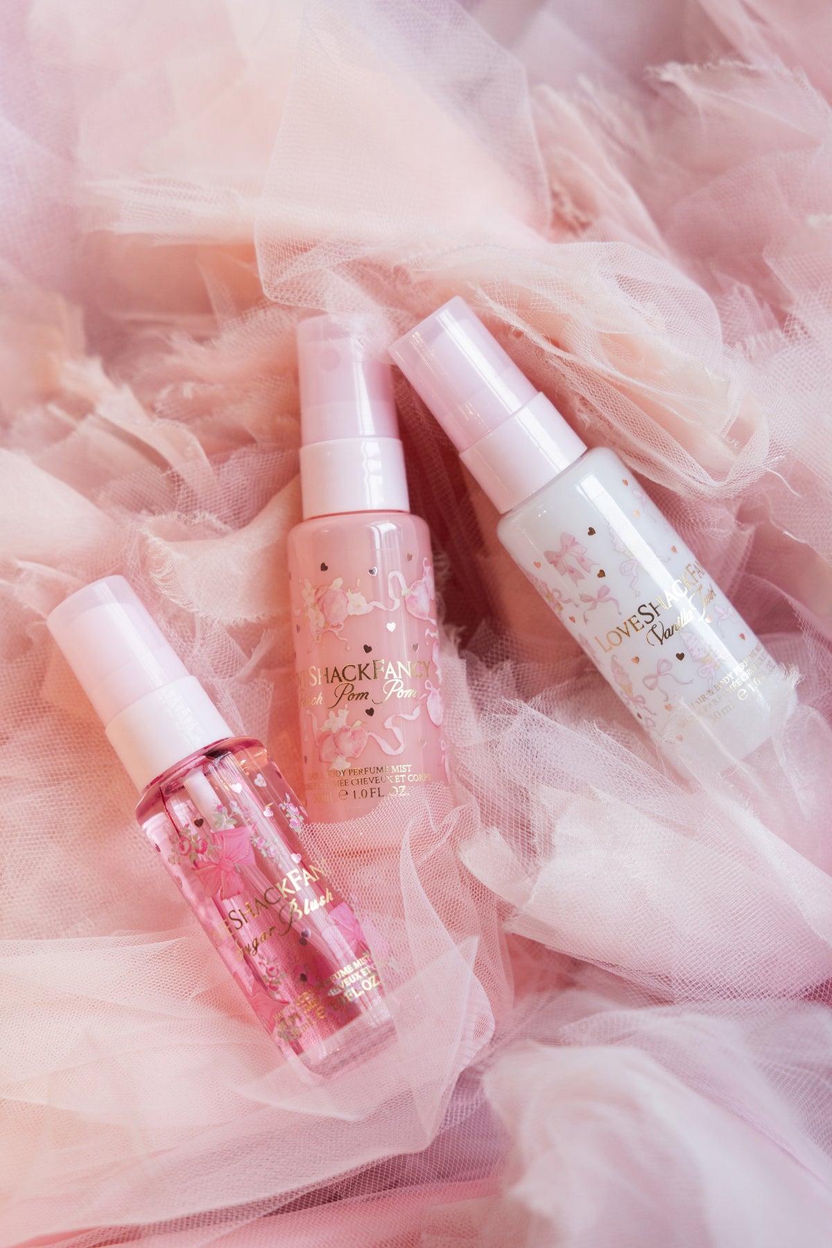 Mini perfume mist bottles set with pink and clear labels, LOVESHACKFANCY