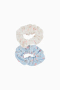 Two floral scrunchies, one white and one blue, on a white background.