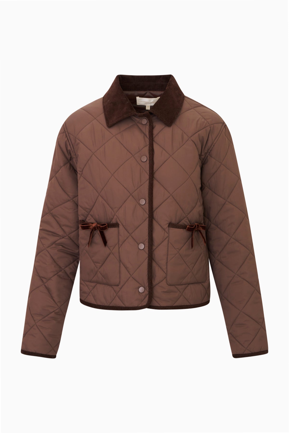 Detail view of brown quilted jacket with dark brown corduroy collar and corduroy trim, snap button front, and front pockets with velvet bow trim