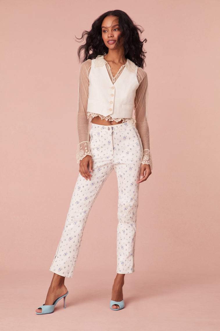 Jeans with a floral print and comfortable stretch fabric. The straight leg pants feature ankle length, zipper details at the sides, a moto-inspired knee patch detail, and a mid to low waistline.