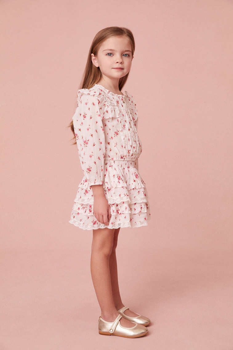Girls skirt with a floral print and custom-lace embroidered tassels. Below a wide smocked waistband, the skirt falls to two shirred tiers with ruffle details.