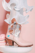 Pink cowboy boot with heart designs on a pink background