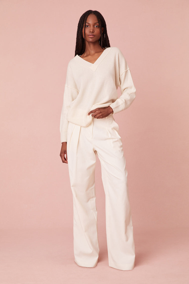 With a v-neckline, this top has a slightly longer length giving it an oversized silhouette. The pullover is finished with a sweet, top-applied embroidered bow on the back of the neck.