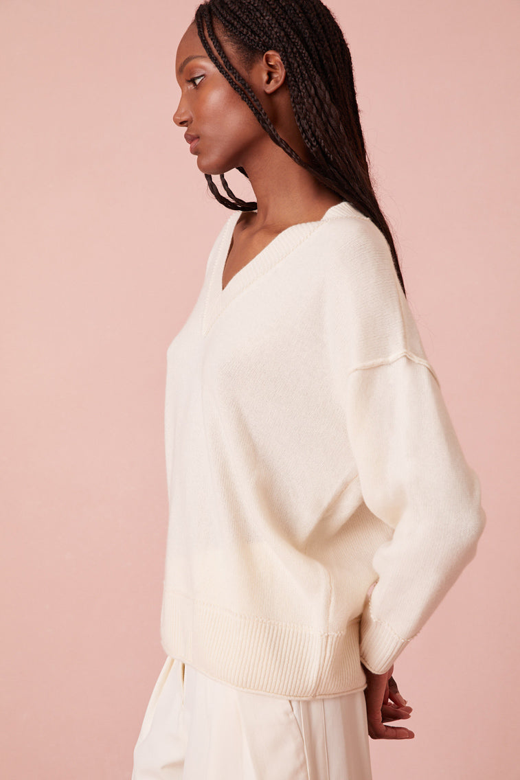 With a v-neckline, this top has a slightly longer length giving it an oversized silhouette. The pullover is finished with a sweet, top-applied embroidered bow on the back of the neck.