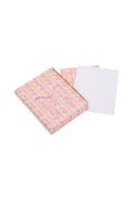 A pink floral card and envelope set, with the envelope placed in front of the card.