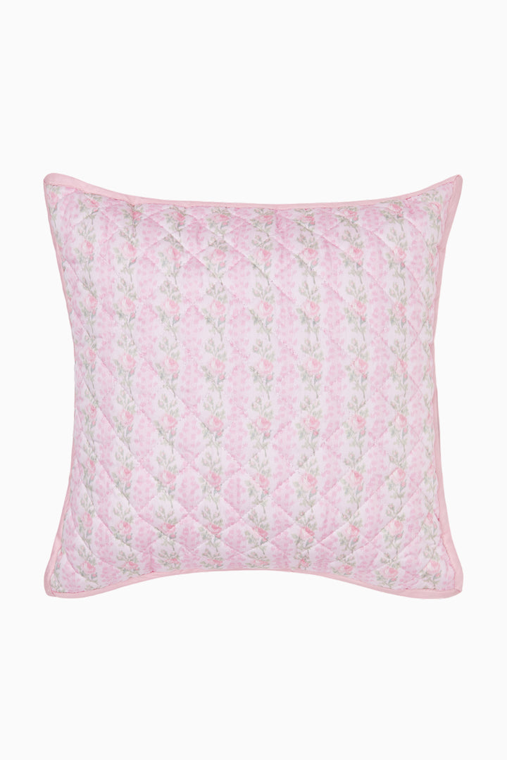 Pink floral quilted pillow on a white background