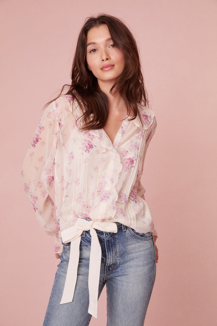Long sleeve top in lavender floral print features a cascading design down the center front.