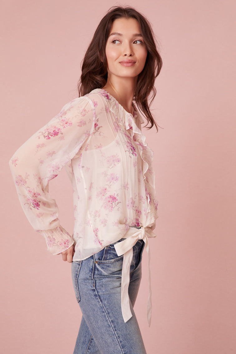 Long sleeve top in lavender floral print features a cascading design down the center front.