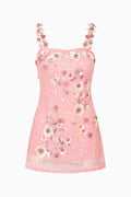 Pink dress with floral and bead embellishments on a white background