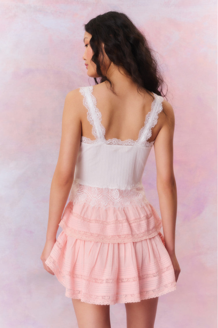 Mini skirt featuring ruffled tiers, intricate inset lace trims, allover pintuck details, and a frayed hem. Includes an elasticated waistband and double lining.