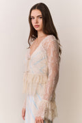 Woman wearing a lace dress with a plain background