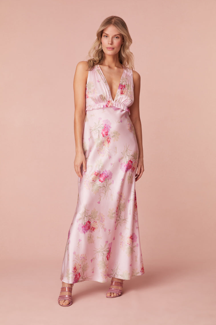 Floral printed maxi dress featuring a v-neckline, a ruched bodice, and a body-skimming skirt.