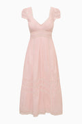 Pink dress with ruffled straps on a white background