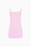 Pink slip dress with lace details on a white background