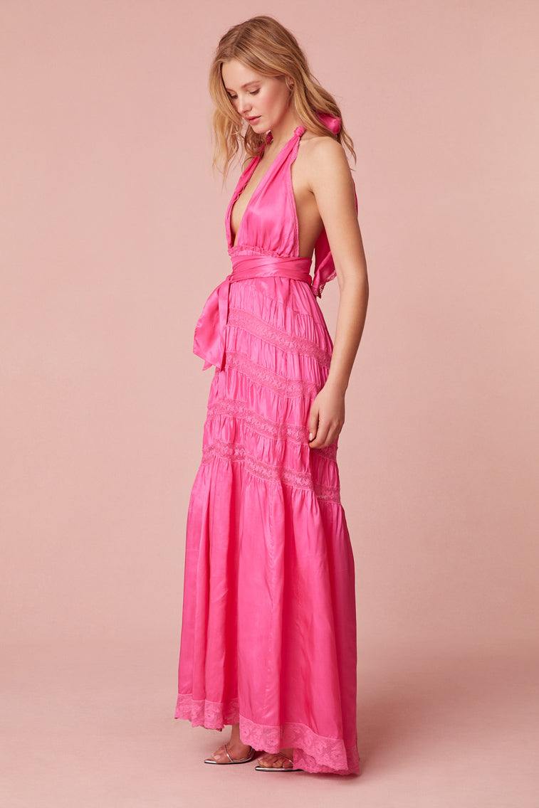 Pink maxi dress with a viscose fabric with laces and textural shirring details all over. Features a deep v-neck, an elasticated waist, and a dramatic skirt with shirring details.