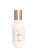 Skincare bottle with floral design and rose gold cap on a white background