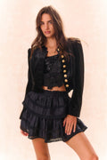Black bow bustier top with sequin-speckled lace panel and layered ruffle design