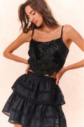 Black bow bustier top with glittery applique, layered ruffles, and narrow straps
