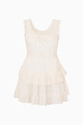 Beige sleeveless dress with ruffled layers on a white background