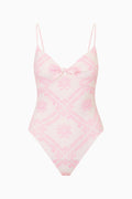 Pink and white patterned swimsuit on a white background