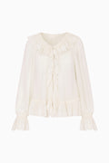 White blouse with ruffled details on a white background