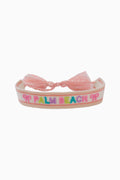 Pink bracelet with 'Palm Beach' text on a white background