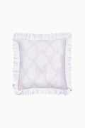 White pillow with ruffled edges and pink embroidery on a white background