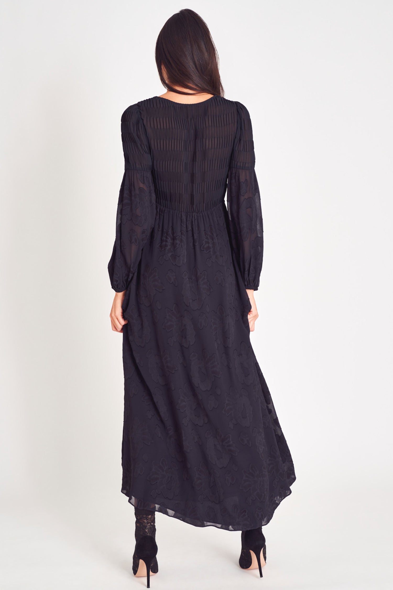 Black v neck long sleeve maxi dress with floral jacquard and pleated texture fabric.