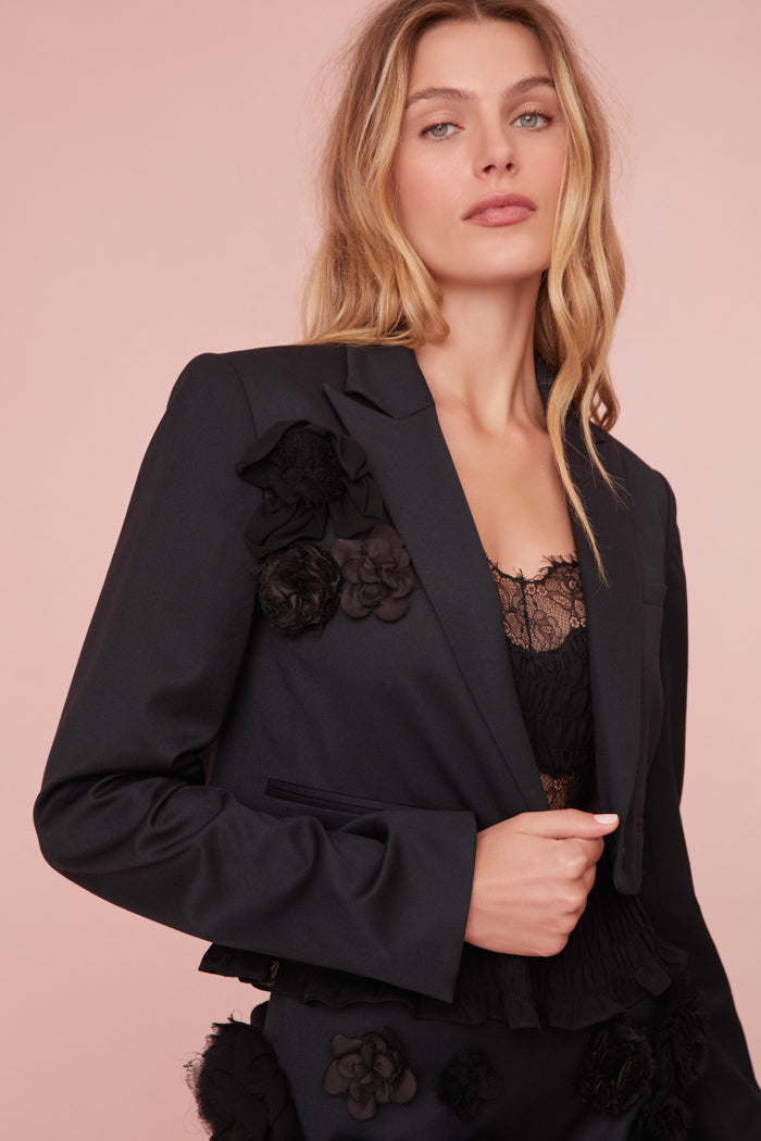 Black cropped blazer featuring handmade rosettes.