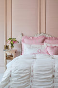 Pink and white bedroom with floral accents