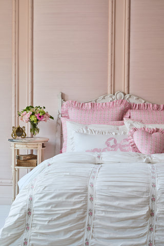 Pink and white bedroom with floral accents