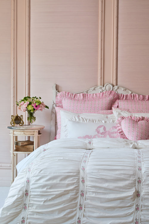 Pink and white bedroom with floral accents