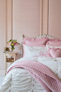 Pink and white bedroom with floral accents