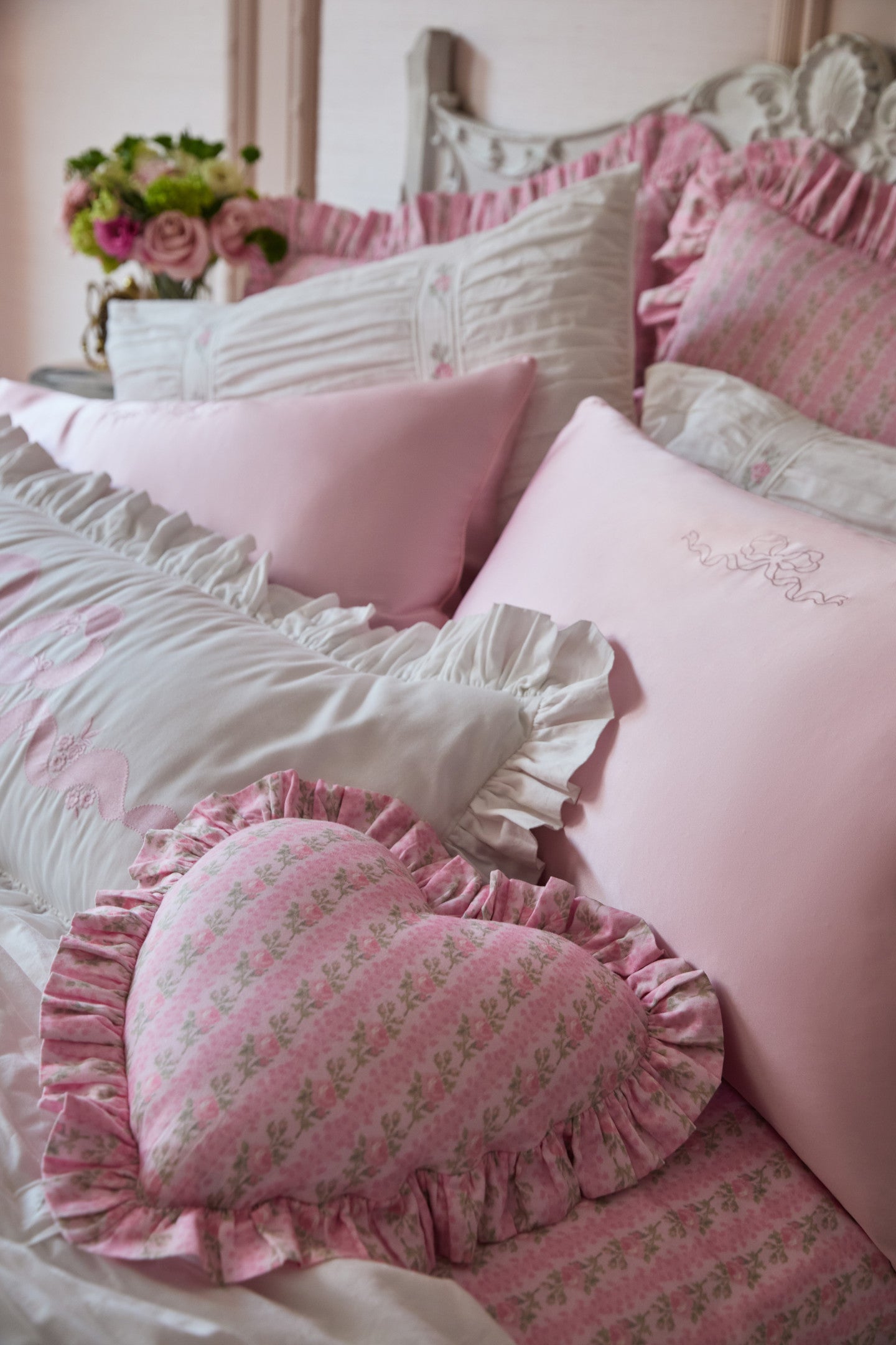 Women sitting in grass field wearing LoveShackFancy Slip Dresses