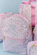Floral-patterned backpack with pink accents on a light blue background
