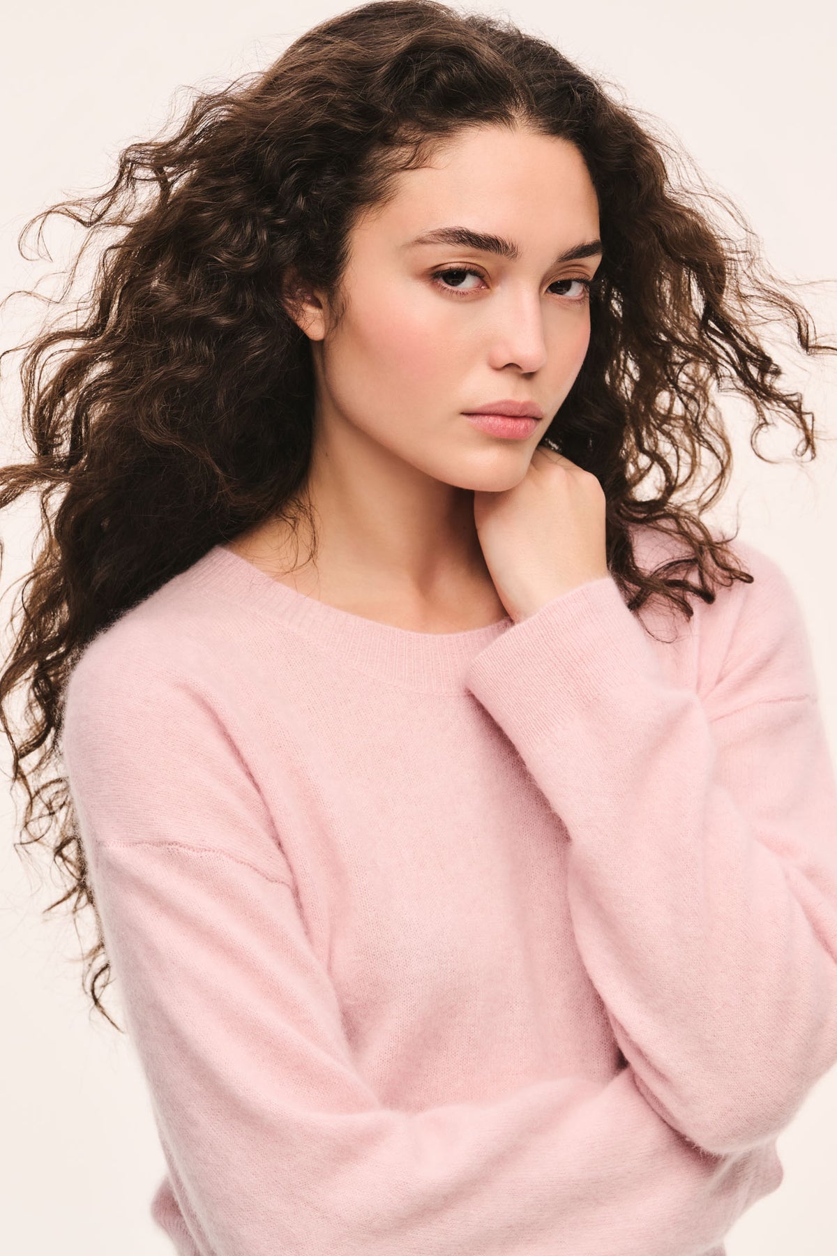 Pink crewneck knit pullover with long sleeves and ribbed neckline detail
