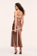 Mocha satin slip skirt with cream lace trim around the hips and vertical trim on edge of the front slit, side view