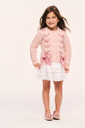Girls' pink cable-knit cardigan front view with large ribbon threaded through and bow at hem