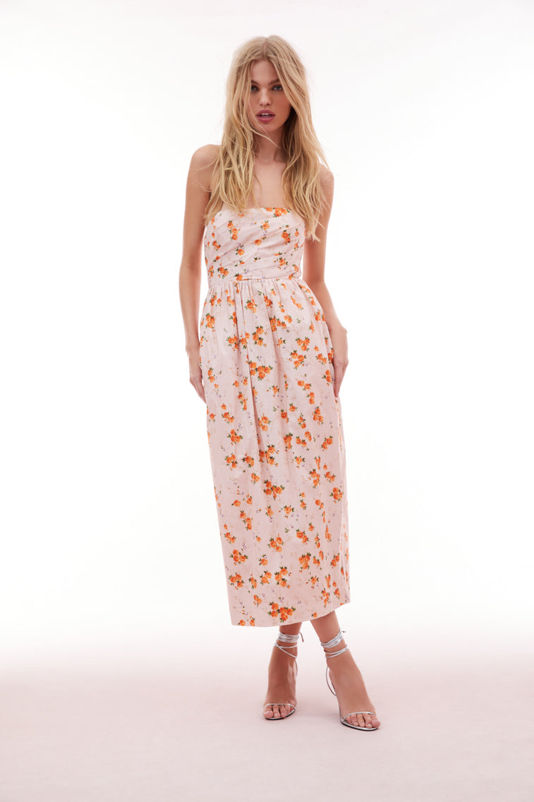 Floral printed midi dress with a tulip silhouette featuring a skirt slightly wider at the hips than tapers down toward the floor. The bodice has an asymmetrical draping, a structural inside with boning for support and a flattering fit with a cinched waist.