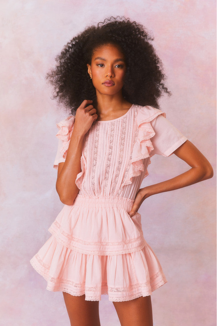 Mini dress with double ruffled flutter sleeves, which cascade down the front and back of the body. Includes an elasticated waist and intricate custom lace panels trimming the skirt’s flounces.