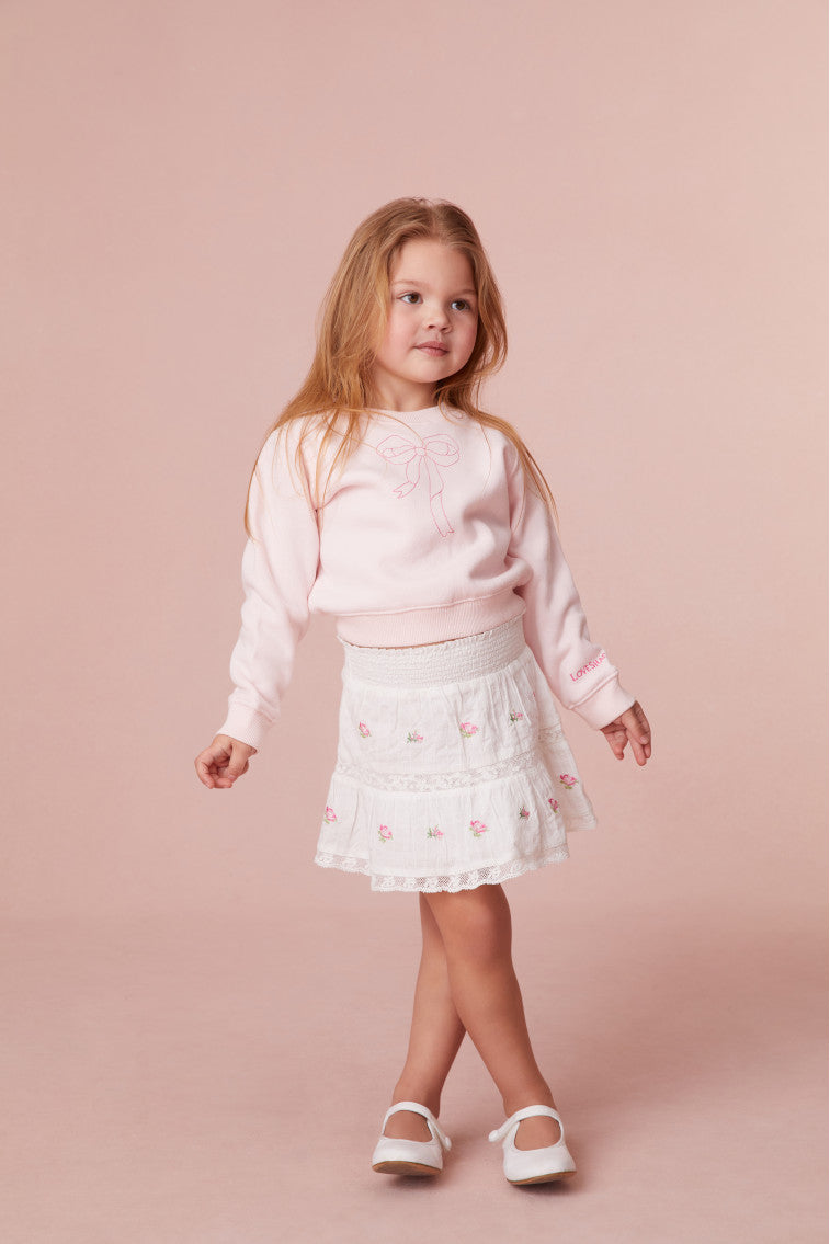 Girls pullover sweater featuring a pink bow print.