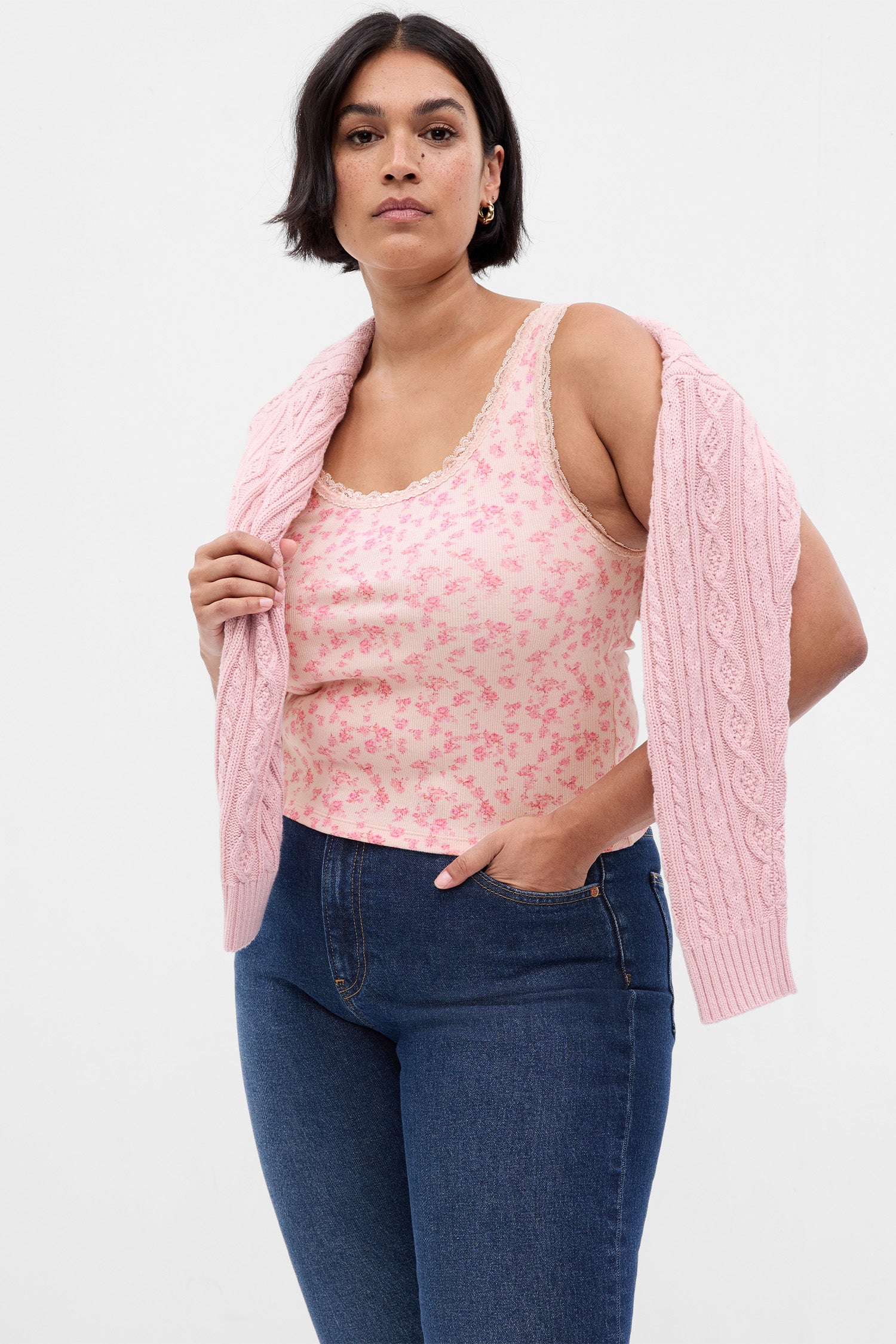 Model wearing pink floral tank top with lace detail at neckline