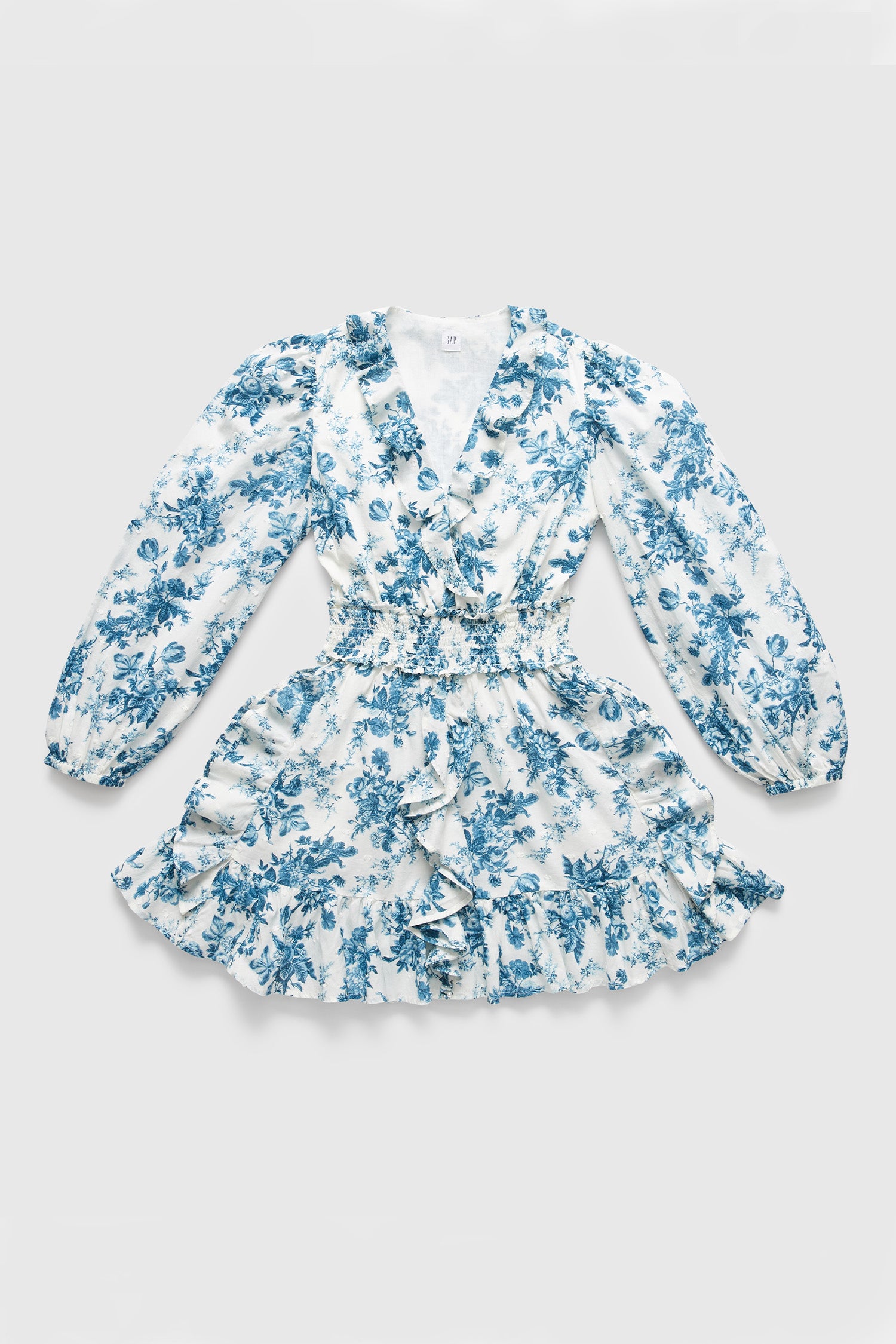 White and blue floral mini dress with puff long sleeves, ruffled hem, and smocked waist