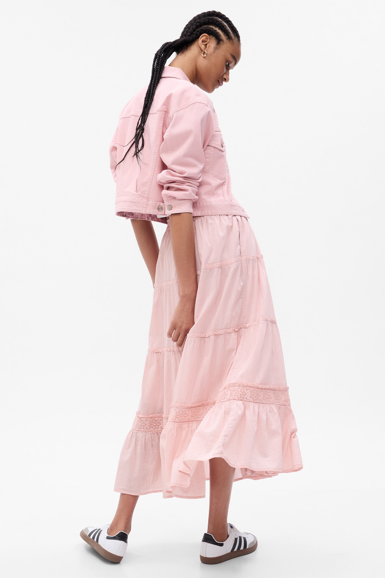 Back image of model wearing pink maxi skirt with eyelet detail and button up front